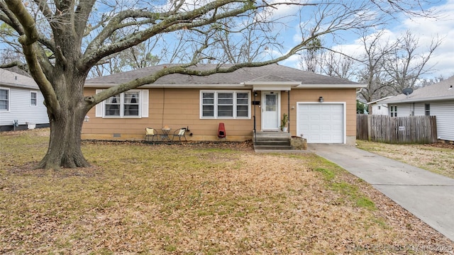 ranch-style home with an attached garage, fence, driveway, crawl space, and a front yard