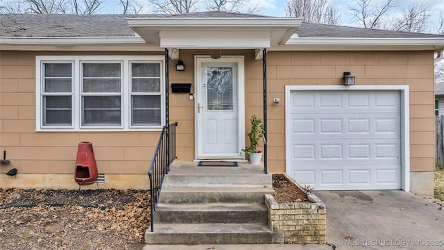 property entrance featuring a garage, driveway, and a shingled roof