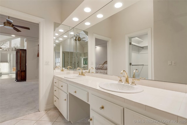 bathroom with double vanity, connected bathroom, ceiling fan, and a sink