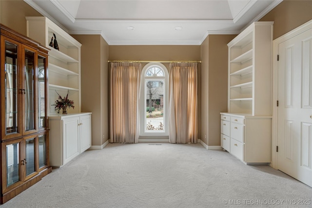 interior space with crown molding, baseboards, and light carpet