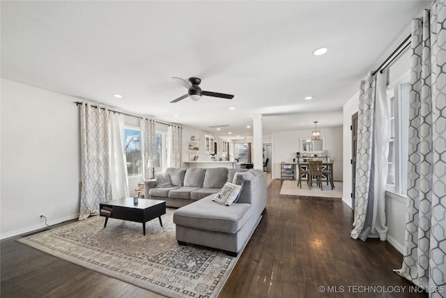 living area featuring recessed lighting, a ceiling fan, baseboards, dark wood-style floors, and decorative columns