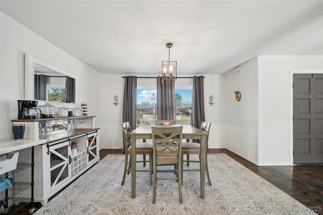 dining room with a chandelier and wood finished floors