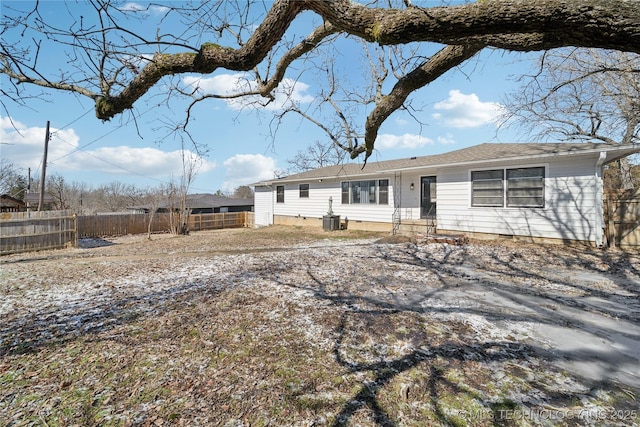 view of front of home featuring fence and central air condition unit