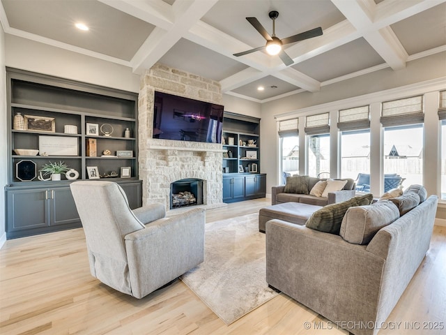 living area with a fireplace, light wood-style floors, ornamental molding, coffered ceiling, and beamed ceiling