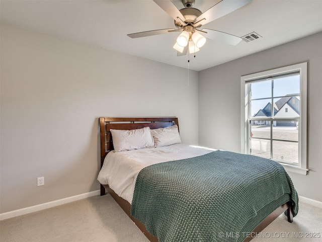 bedroom featuring ceiling fan, carpet flooring, visible vents, and baseboards