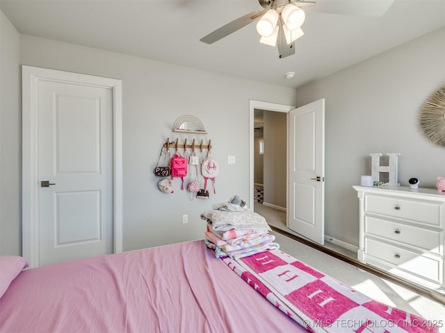 bedroom with a ceiling fan and baseboards