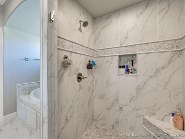 full bathroom featuring a bathtub, marble finish floor, and a marble finish shower