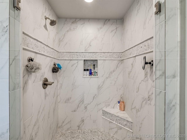 bathroom with a marble finish shower