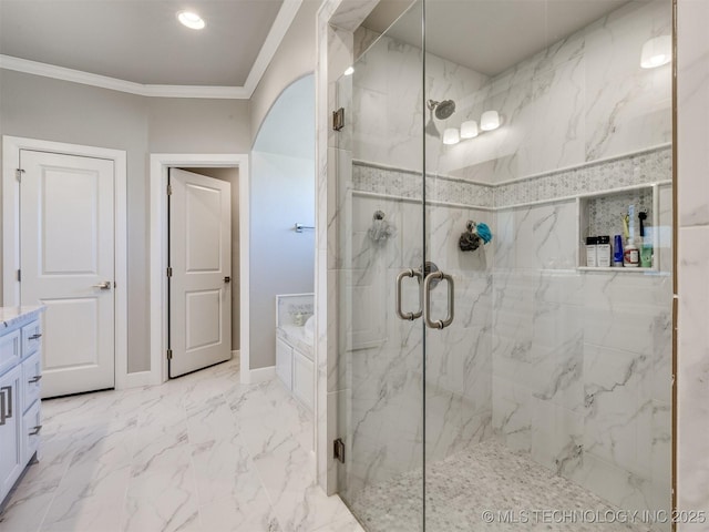 bathroom featuring a marble finish shower, a garden tub, marble finish floor, crown molding, and vanity