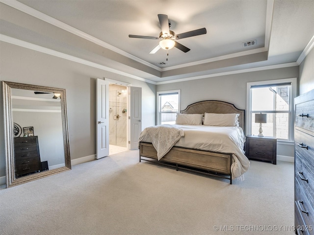 carpeted bedroom featuring baseboards, a raised ceiling, and crown molding