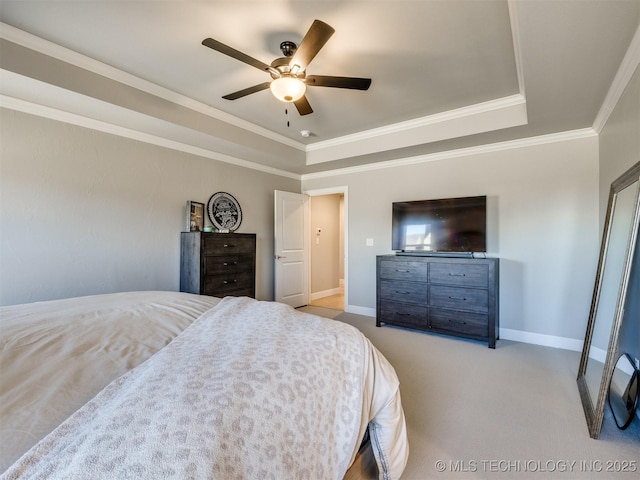 bedroom featuring a raised ceiling, carpet flooring, and baseboards