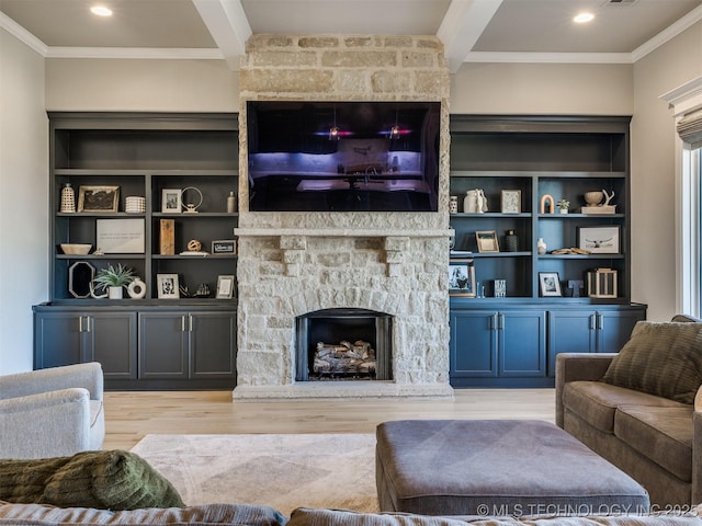 living area featuring ornamental molding, a fireplace, wood finished floors, and beam ceiling