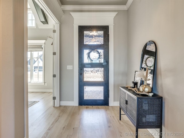 entryway featuring ornamental molding, wood finished floors, and baseboards