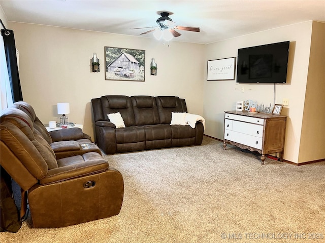 carpeted living room featuring baseboards and a ceiling fan