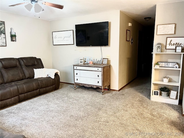 living room with carpet, ceiling fan, and baseboards