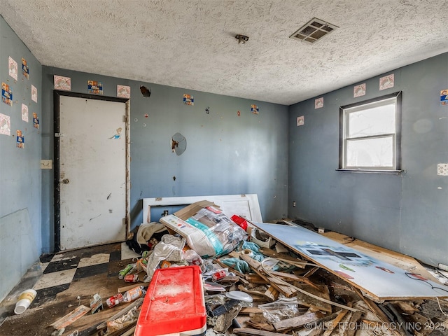 miscellaneous room featuring visible vents and a textured ceiling