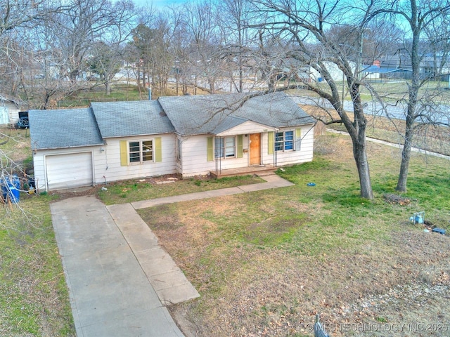 ranch-style house with a front lawn, driveway, a shingled roof, and an attached garage