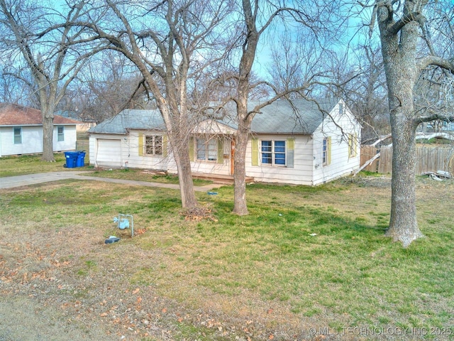 single story home with a garage, concrete driveway, a front lawn, and fence