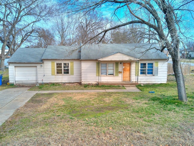 single story home with a garage, concrete driveway, and a front lawn