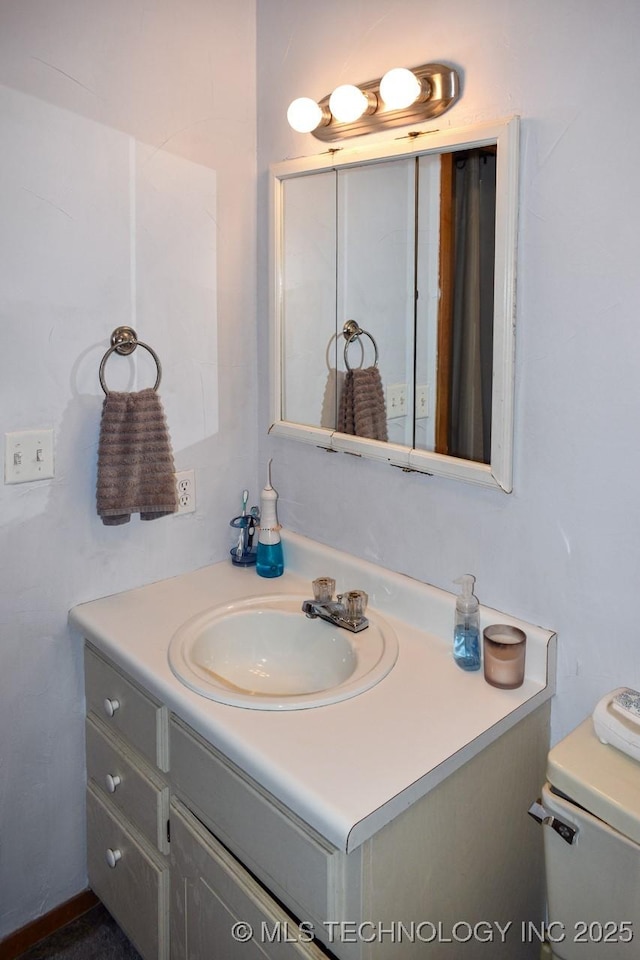 bathroom featuring vanity and toilet