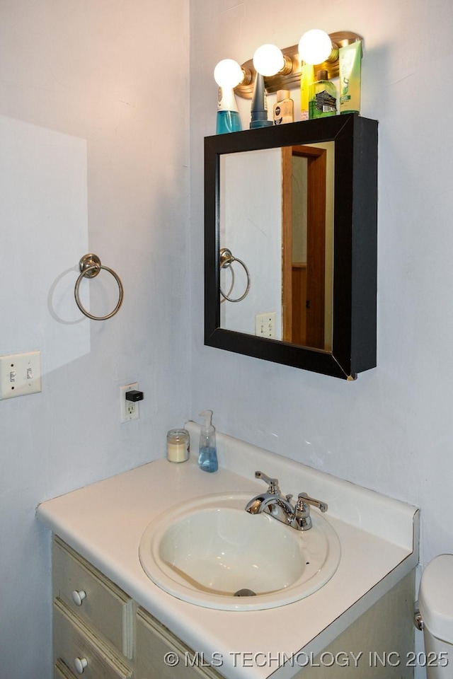 bathroom with toilet and vanity