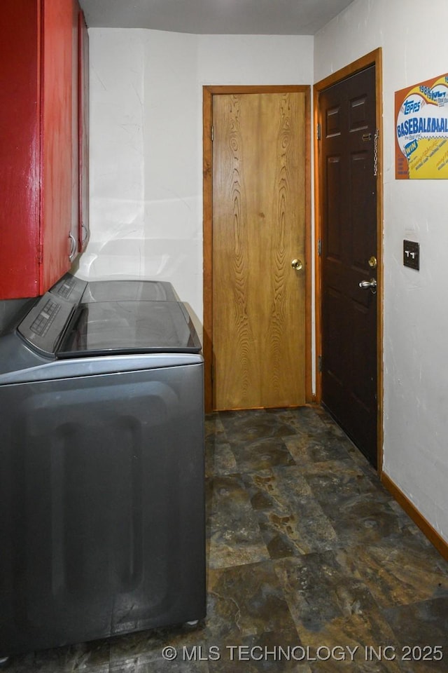 washroom with washer / dryer, stone finish flooring, laundry area, and baseboards