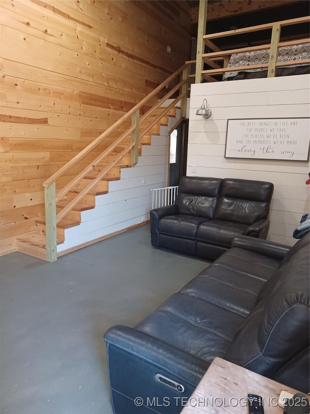 116965 S 4164, Eufaula, OK 74432 - living area with finished concrete flooring, wood walls, and stairway