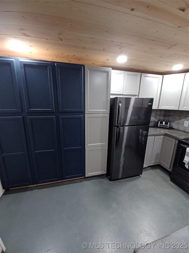 116965 S 4164, Eufaula, OK 74432 - kitchen with wooden ceiling, concrete floors, white cabinetry, freestanding refrigerator, and dark countertops