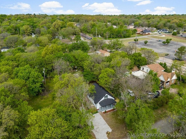 birds eye view of property featuring a wooded view