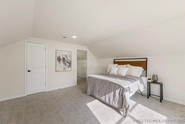 bedroom featuring lofted ceiling, carpet flooring, visible vents, and baseboards