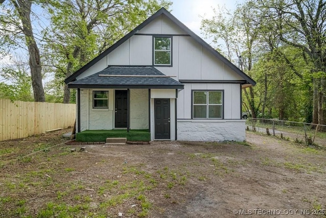 view of front of property with fence private yard and roof with shingles