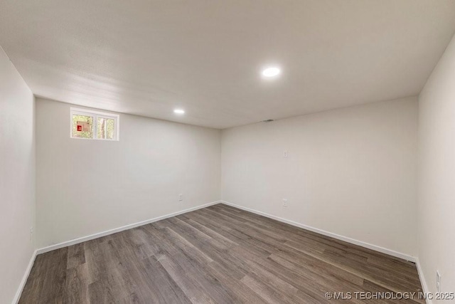 empty room featuring recessed lighting, baseboards, and wood finished floors