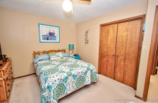 bedroom featuring carpet floors, ceiling fan, baseboards, and a closet