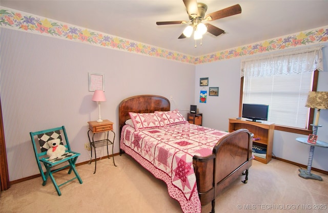 carpeted bedroom featuring a ceiling fan and baseboards