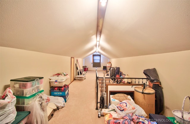 recreation room with carpet floors, vaulted ceiling with beams, and a textured ceiling