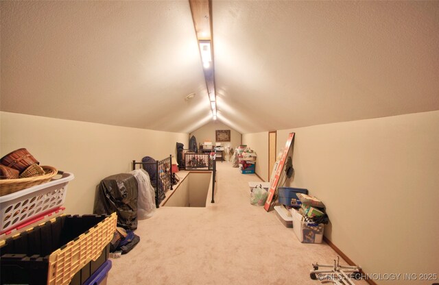 bonus room with vaulted ceiling and carpet flooring