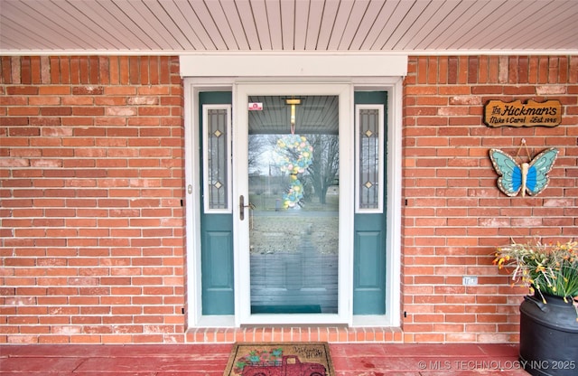 property entrance with brick siding