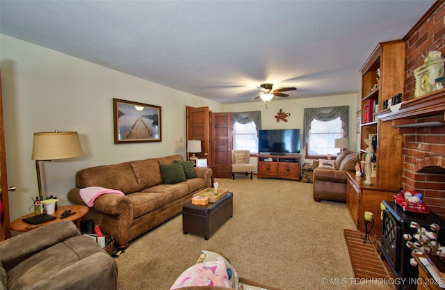 living room with carpet floors, a brick fireplace, and ceiling fan