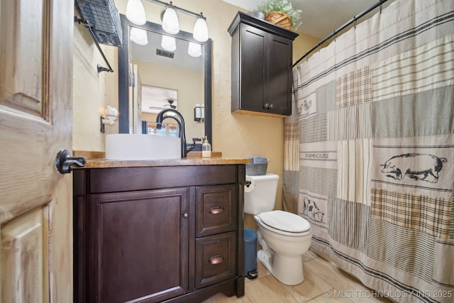 448 Springview Dr, Skiatook, OK 74070 - bathroom with toilet, vanity, a textured wall, a shower with curtain, and tile patterned flooring