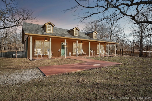 view of front facade with a ceiling fan and fence