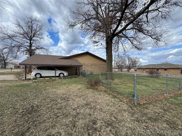 view of property exterior with fence and a lawn