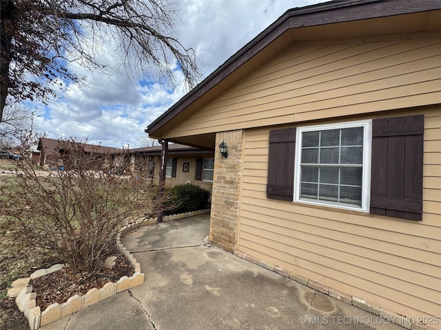 view of side of home with a patio