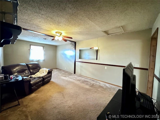 living area featuring carpet floors, visible vents, attic access, ceiling fan, and a textured ceiling