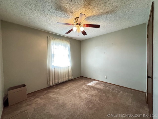 unfurnished room featuring carpet floors, ceiling fan, a textured ceiling, and baseboards