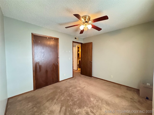 unfurnished bedroom with a textured ceiling, a closet, visible vents, and baseboards