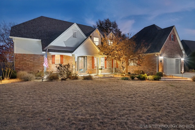 view of front facade with covered porch and brick siding