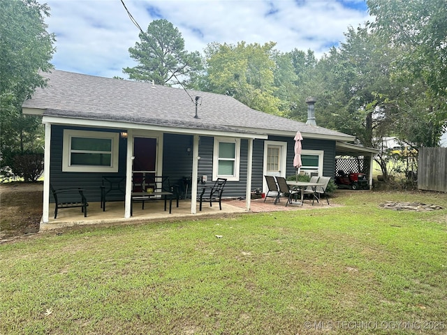 back of house with a patio area, fence, a lawn, and roof with shingles