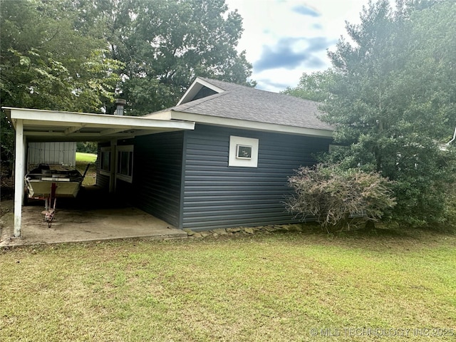 view of home's exterior with roof with shingles and a lawn