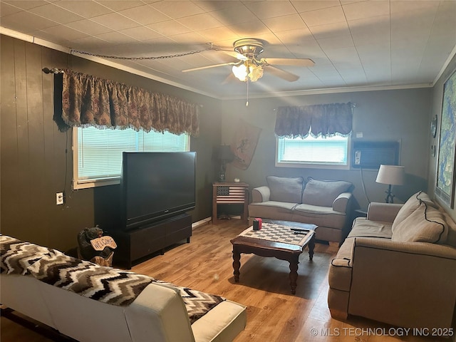 living room with light wood-style flooring, ornamental molding, and ceiling fan