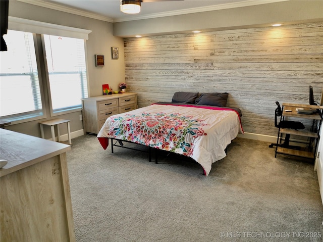 bedroom featuring light carpet, wood walls, baseboards, and crown molding